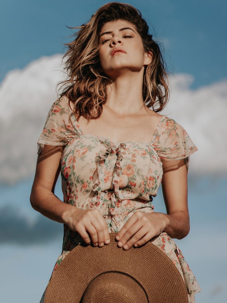 photo-of-woman-in-floral-dress-holding-a-sun-hat-and-posing-3034889